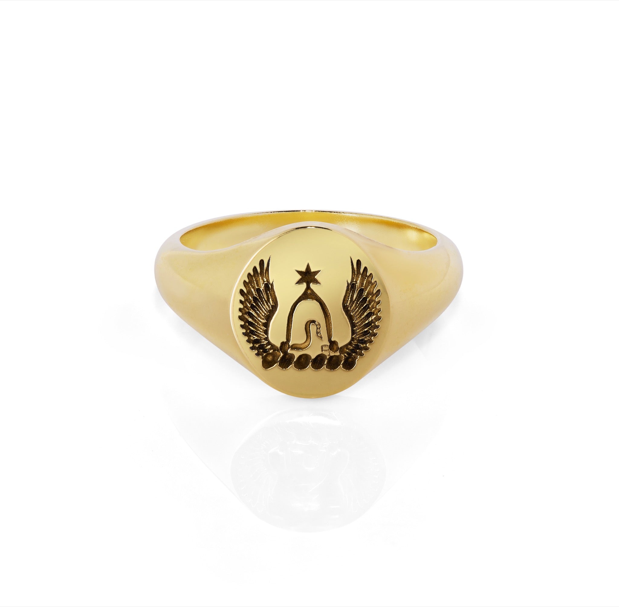 bepsoke pinky signet ring Trilogy yellow diamond ring made from 18ct yellow gold with family crest hand engraved on it, lying on white background with shadow