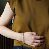 Model wearing mustard knitting top and silver Artemisia Necklace and Bracelet