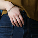 Close up of model wearing jeans and silver Artemisia Chain with hands in her pocket