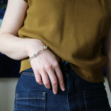 Model wearing jeans and silver Artemisia Chain with hands in her pocket