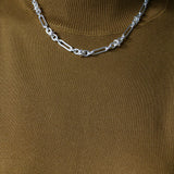 Model wearing mustard knitting top and silver Artemisia Necklace and Bracelet