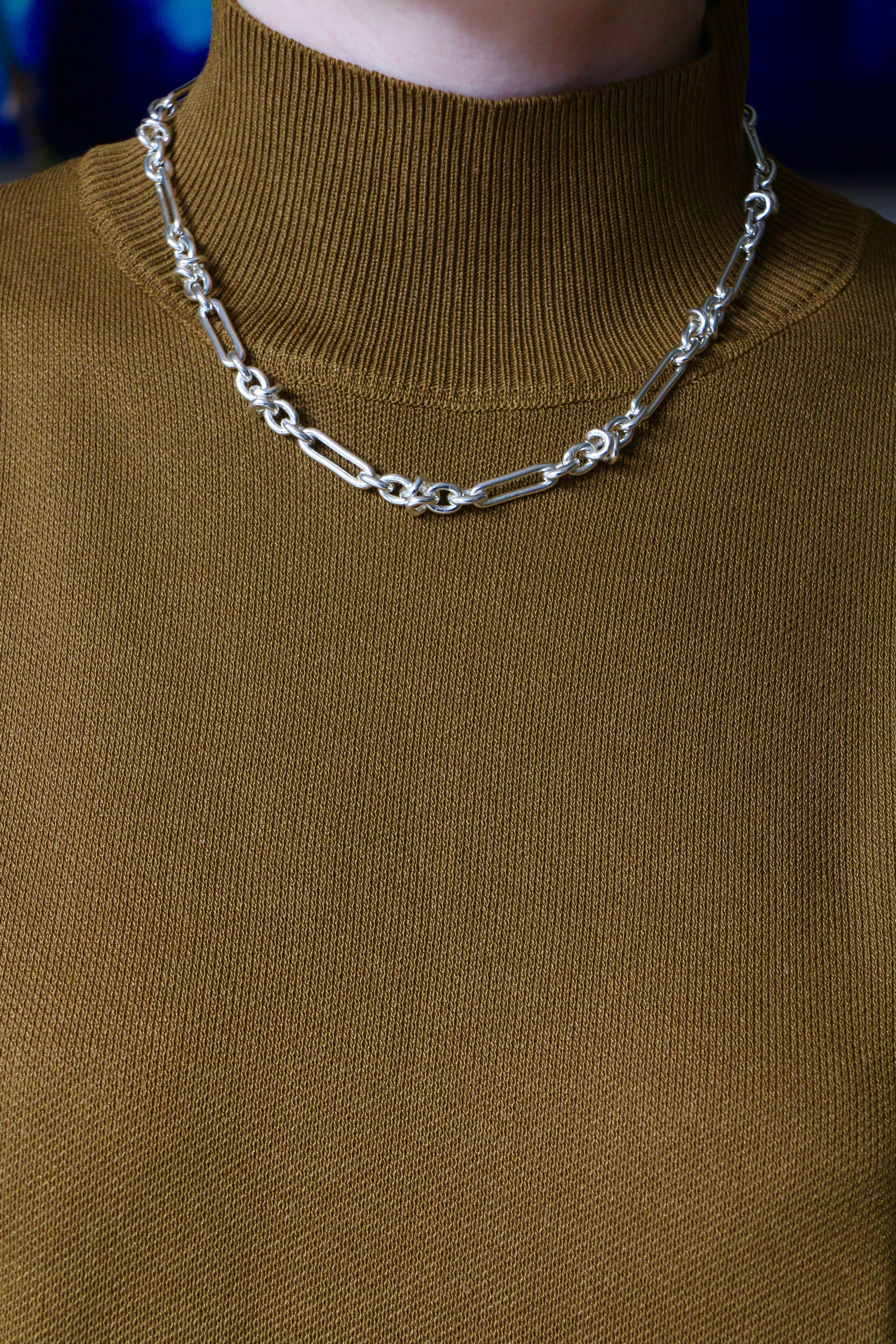 Model wearing mustard knitting top and silver Artemisia Necklace and Bracelet