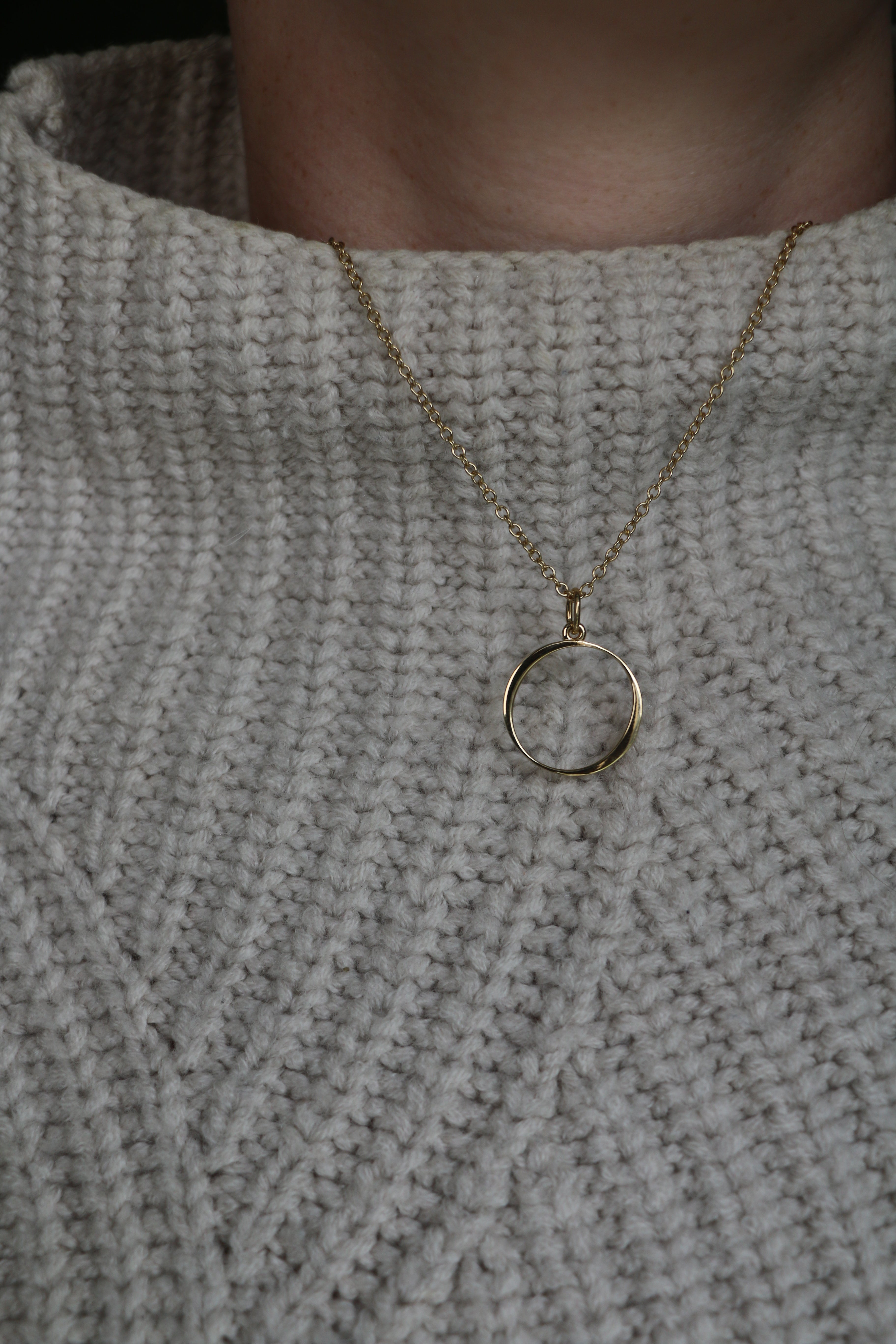 O Gold Necklace worn by model wearing white knitted jumper