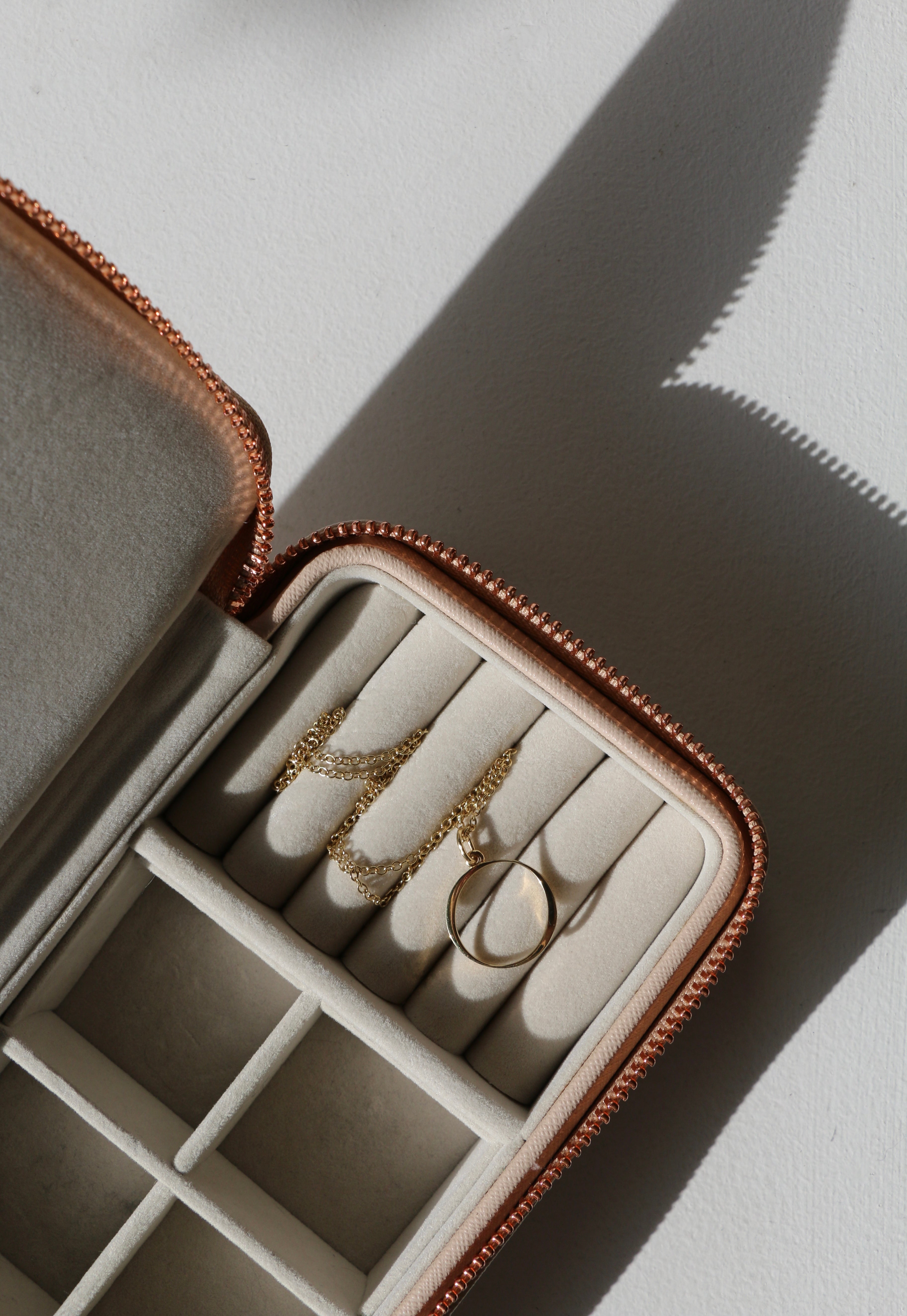 O Initial Necklace in pink detailed jewellery box on white ledge with shadows