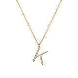 K Anne Initial on gold chain on white background