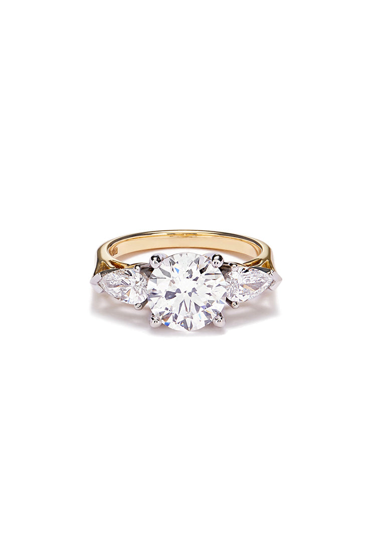 Trilogy Diamond ring set in gold and platinum lying on a white background with shadow