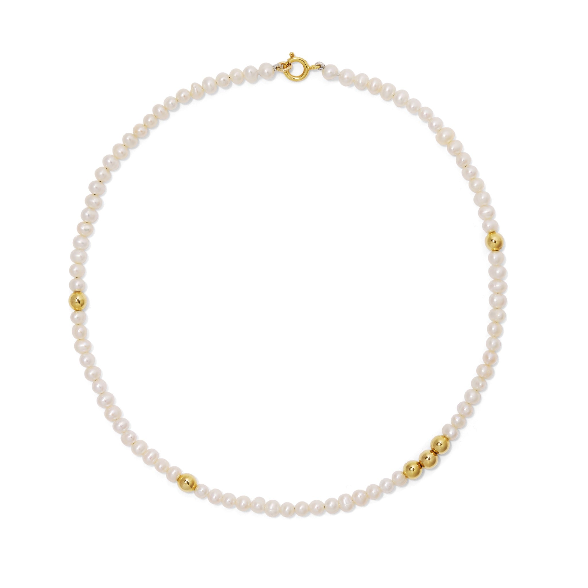 Grace Pearl and Gold bead necklace lying on white background