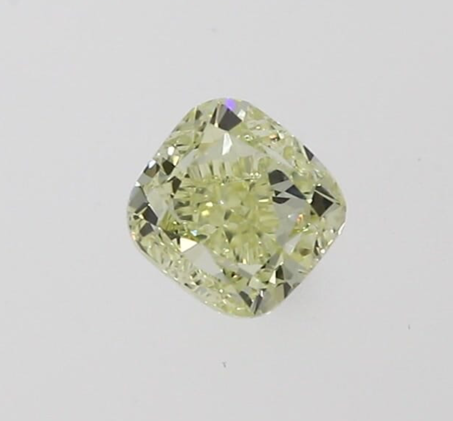 Image of a light fancy yellow, cushion cut diamond on a white background
