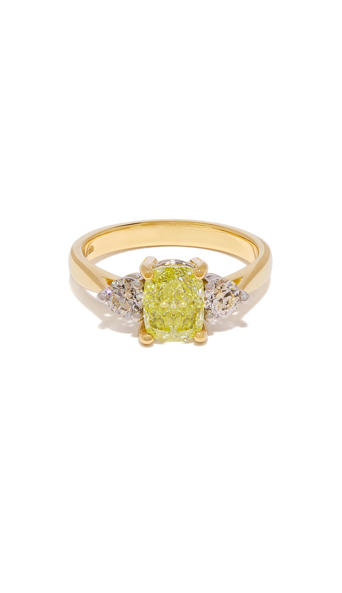 Trilogy yellow diamond ring set in 18ct yellow gold and platinum lying on white background with shadow