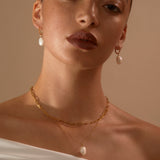 Model in a studio wearing Cecilia + Hedy Pearl Drops and Anna Pearl Pendant with Jenny trace Chain