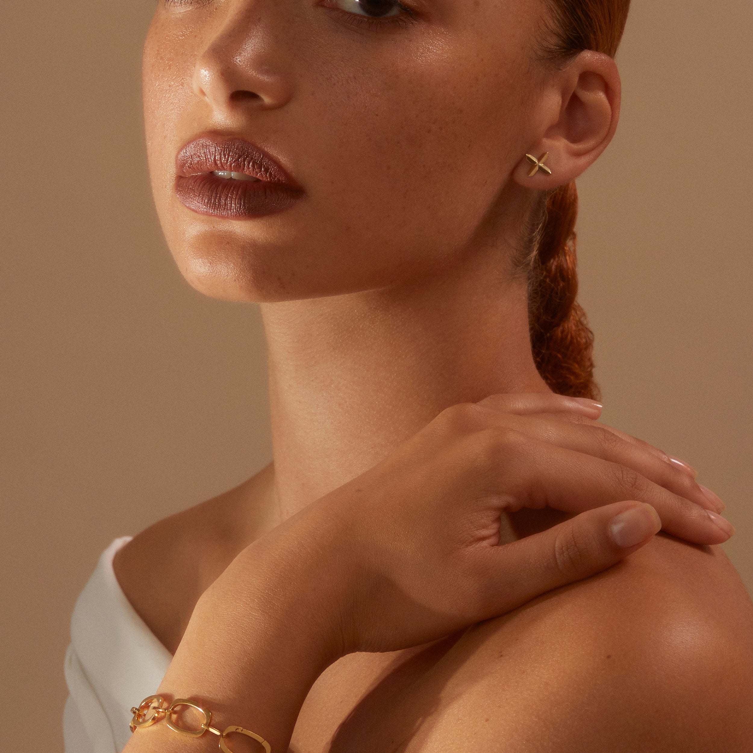 Model looking to camera wearing our gold vermeil Nancy Chain Bracelet