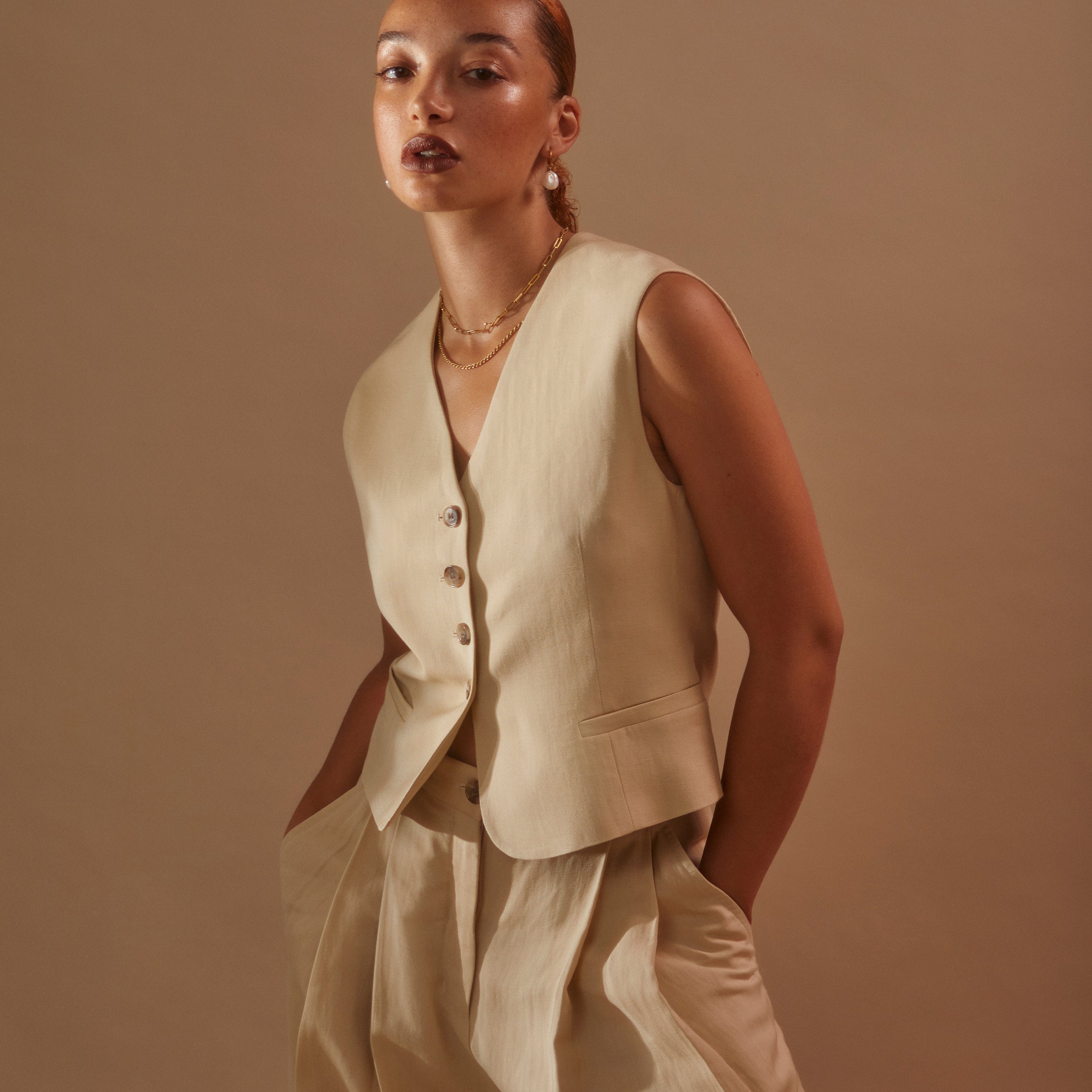Model wearing Rosalind + Jenny Layering set with beige linen suit