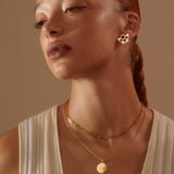 Model looking past camera wearing our Jenny trace chain and personalised Octagon Strength Charm Necklace