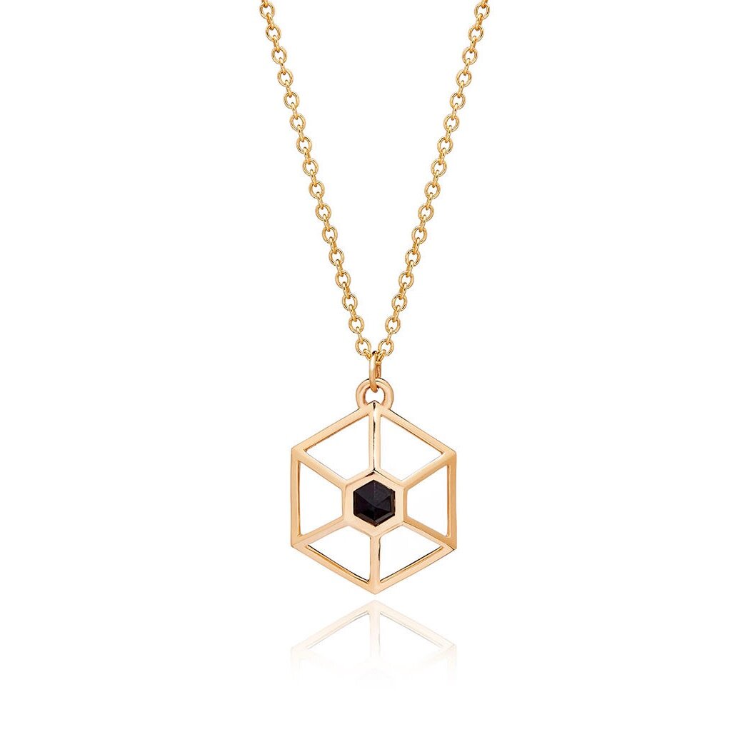 Circe Hexagon Necklace hanging on gold chain on white background