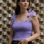 Image of model wearing lilac strappy top and black jeans with our C Anne Initial Necklace