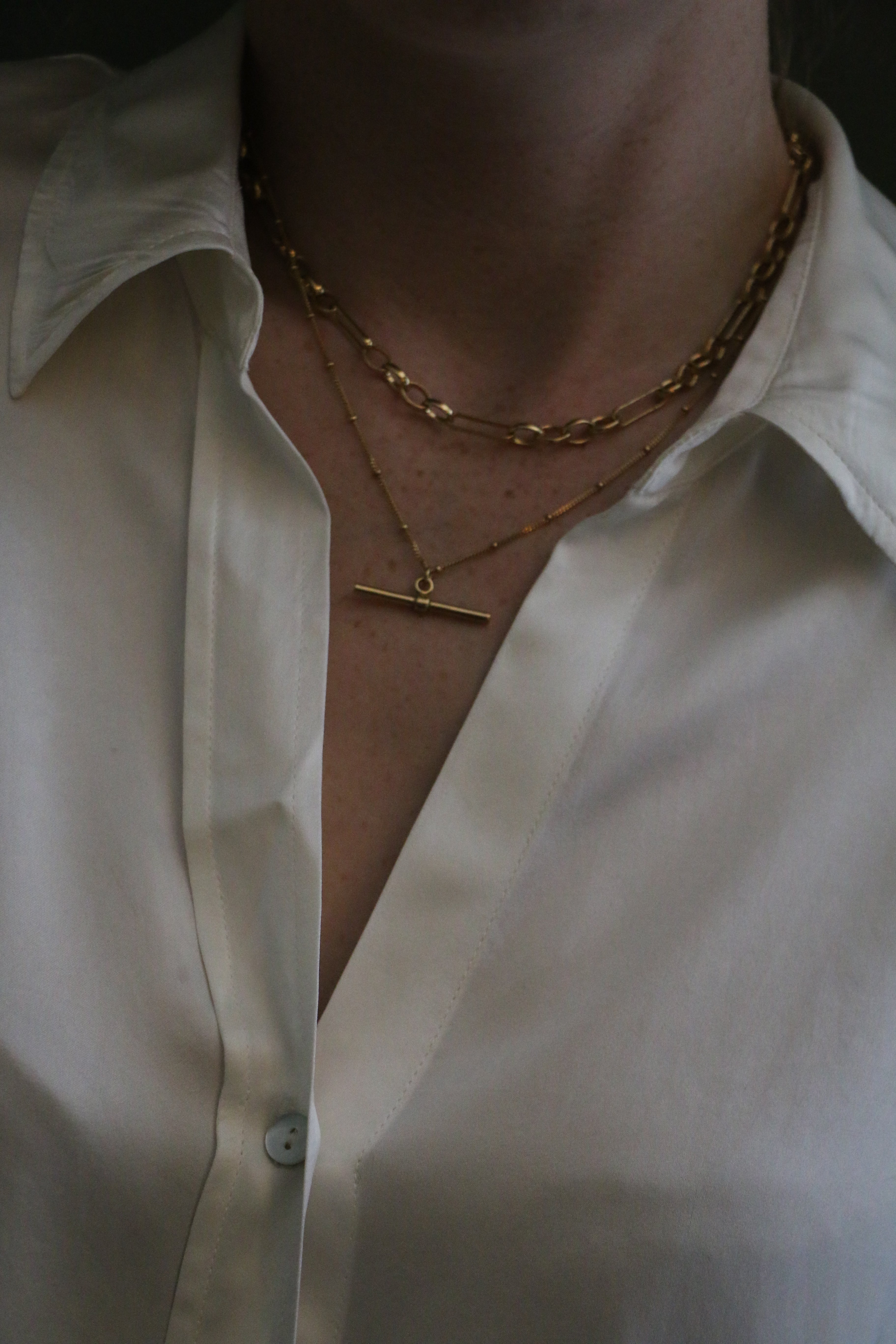 Close up of model wearing a silk white shirt and our 18 inch Marlene T-Bar Necklace