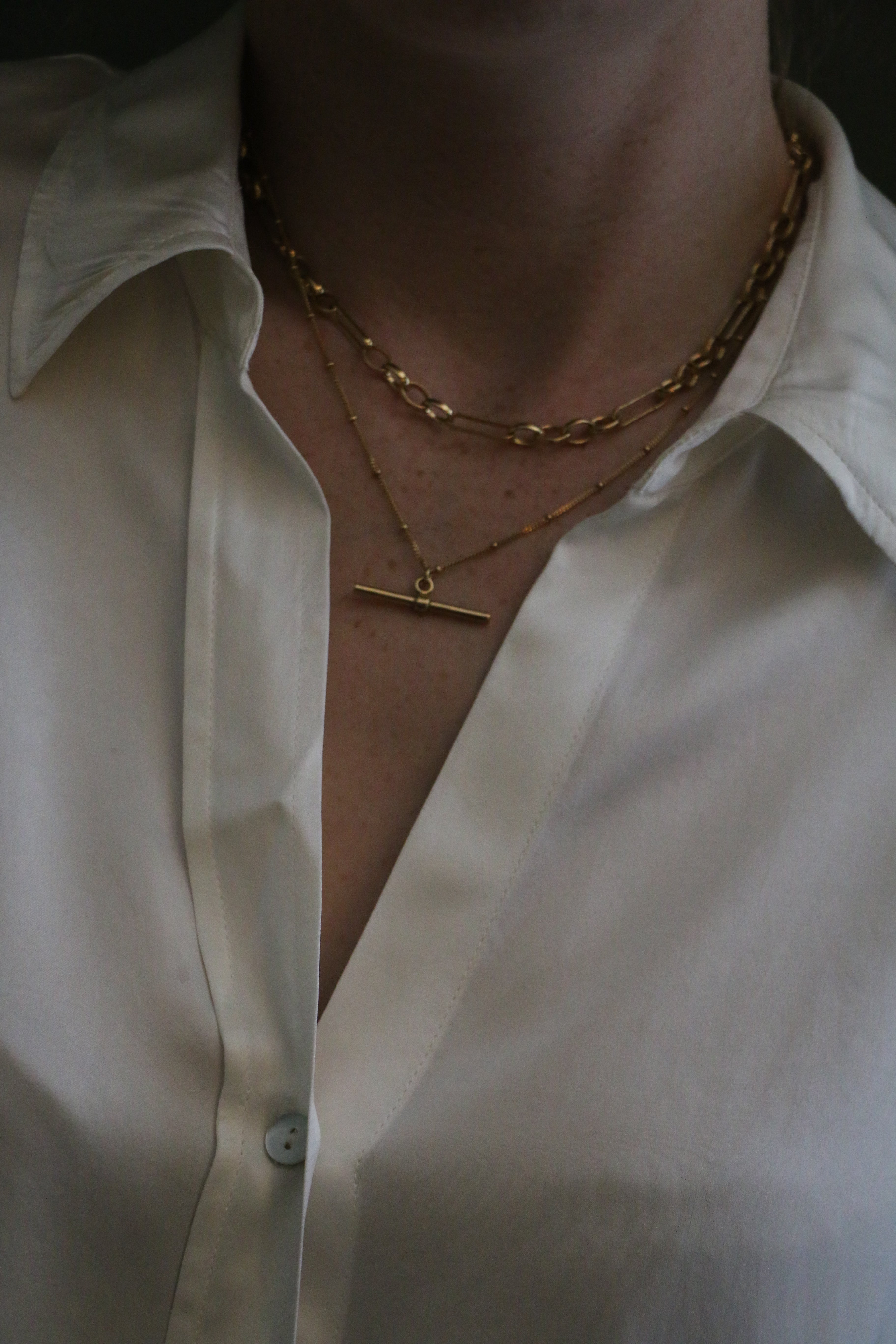 Close up of model wearing a silk white shirt and our 18 inch Marlene T-Bar Necklace 