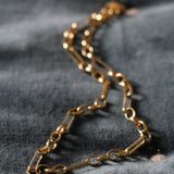 Antonia Guise Mary Figaro Chain lying on a blue velvet surface