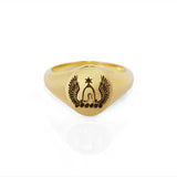 Scalloped signet ring in yellow gold with family crest engraving on a white background