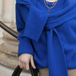 Close up of model wearing blue jumper holding her handbag styled with our handmade Rosalind + Jenny Layering set