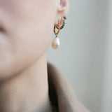 Close up of Cecilia Huggie Hoops and Hedy Pearl Drops along with other studs