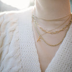Our Model wearing a chunky white knit cardi and a selection of Antonia Guise Necklaces 