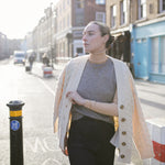 Model walking towards the camera on Bermondsey Street wearing a white cardigan and out handmade Marlene T-Bar Necklace 