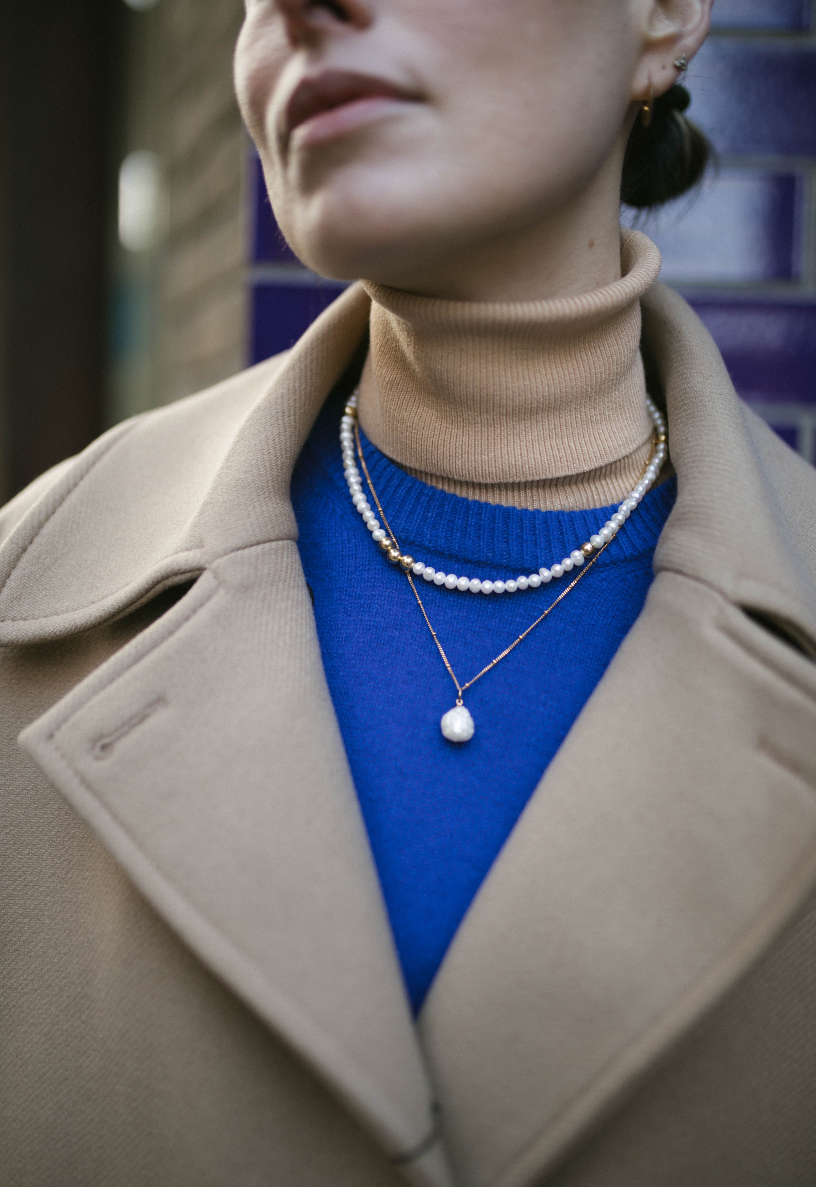 Model wearing blue jumper and our Grace Pearl and Gold bead Necklace