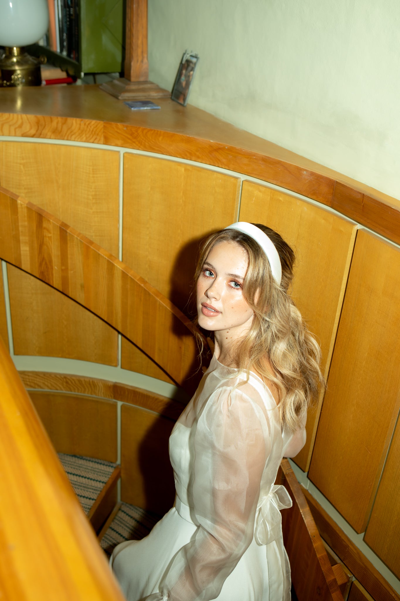 Bride walking up stairs in Andrea Hawkes wedding dress with bespoke diamond engagement ring from Antonia Guise