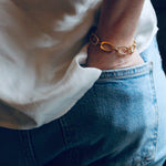 Image of model wearing blue jeans and white silk shirt along with our handmade Nancy Chain Bracelet
