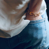 Image of model wearing blue jeans and white silk shirt along with our handmade Nancy Chain Bracelet