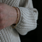 Close up of model wearing white knit jumper and our handmade Mary Figaro Bracelet