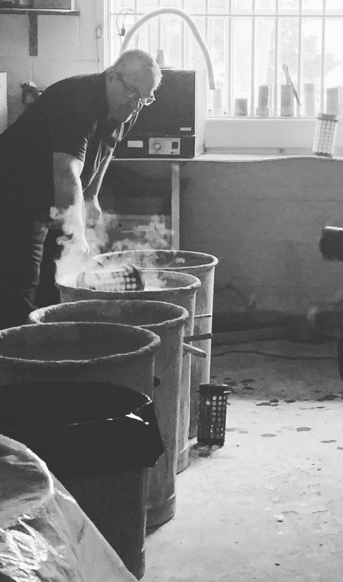 Black and White Image of one of our workshop employees working with moulds in the workshop