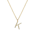 K Anne Initial on gold chain on white background