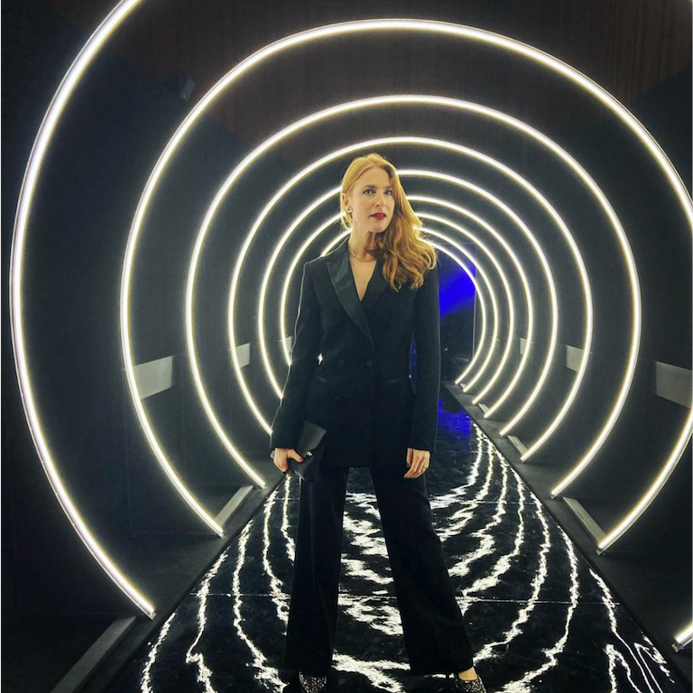 Image of Rosalie Mae Craig at the Netflix premier of her show, wearing a black tux, our Delilah Earrings, Eve Ring and Rosalind Chain
