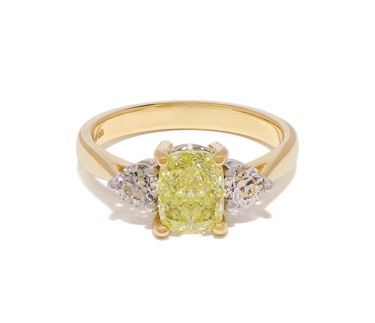 Designed by unique, engagement ring designer Antonia Guise - a trilogy diamond engagement ring featuring a stunning yellow diamond and two round diamond side stones. 