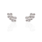 Pair of bezel set round diamonds clustered into wing shaped earrings on a white backgorund