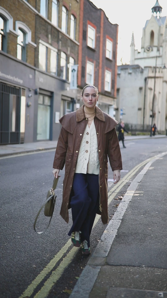 Video of model walking down Bermondsey Street wearing jeans and a wax jacket and our Mary Figaro Chain necklace in gold vermeil