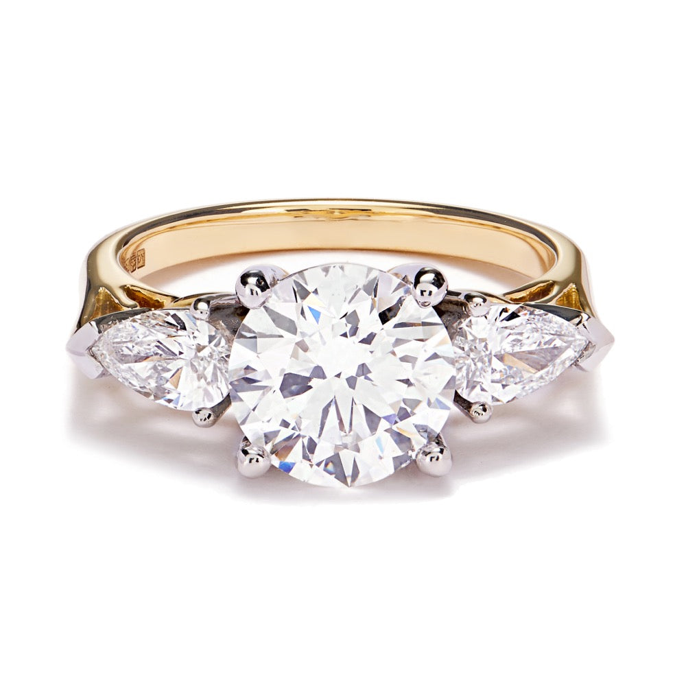 Trilogy diamond ring with gallery detailing lying on a white background