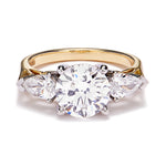 Trilogy diamond ring with gallery detailing lying on a white background