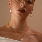 Model in a studio wearing Cecilia + Hedy Pearl Drops and Anna Pearl Pendant with Jenny trace Chain