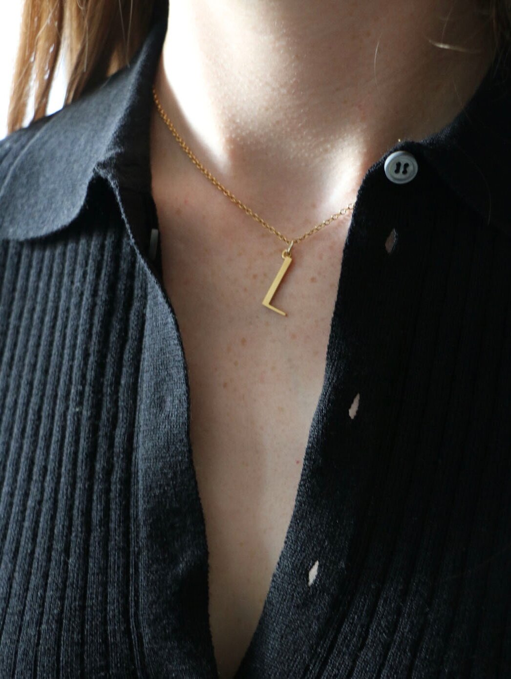 L Necklace worn by model with black collared top